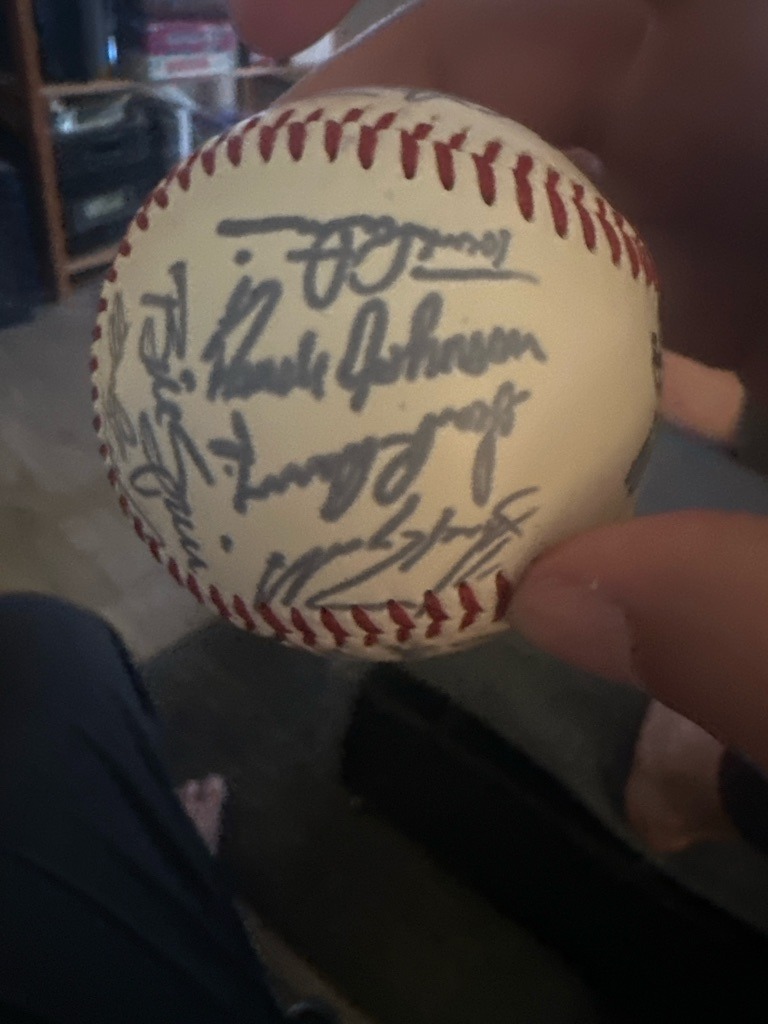 Randy Johnson (prominently featured multi-signed ball including others such as Ozzie Smith or similar)